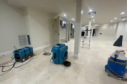 Dehumidifier and air mover drying a finished basement